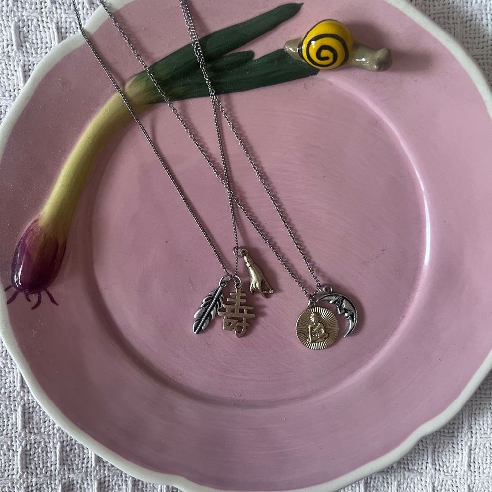 Layered necklace with spiritual charms.